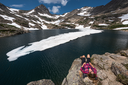Hiker Girl rests at Blue lake Brainard Lake Recreation Areaの写真素材
