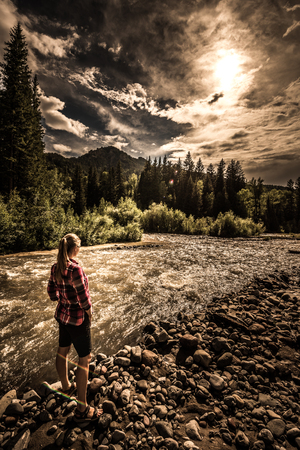 Hiker wearing checkered shirt stands near the Cimarron River Ouray Coloradoの写真素材