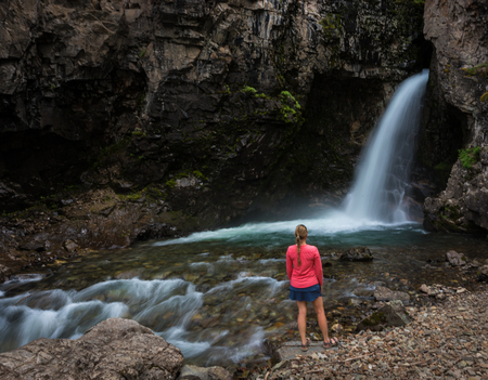 Whitmore Falls Near Lake City, Colorado Girl stands near the waterfallの写真素材
