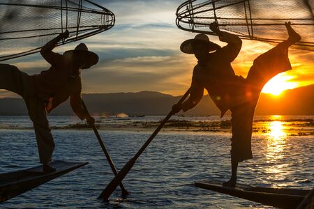 Intha fishermen posing with conical nets at sunset, Inle Lake in the Nyaungshwe Township part of Shan Hills in Myanmar Burmaの写真素材