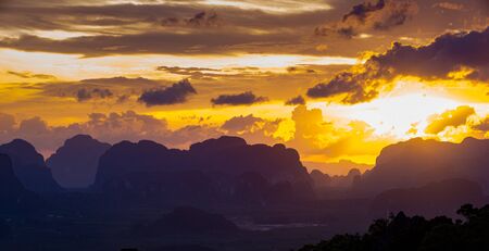 Beautful sunset behind limestone mountains, as seen from the top of Tiger Cave Temple (Wat Tham Sua) Krabi, Thailandの写真素材
