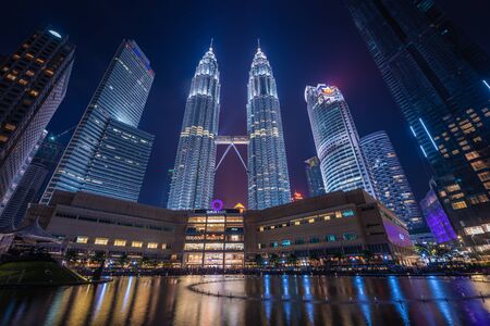 Kuala Lumpur, Malaysia. April 28, 2018: Night view of Petronas Twin Tower KLCC and Symphony Lake, the most attractive place in Malaysia. Night sky with highest buildings.のeditorial素材