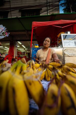 Yangon, Myanmar. December 24, 2018: An unidentified Burmese woman selling bananas at the  local market.のeditorial素材
