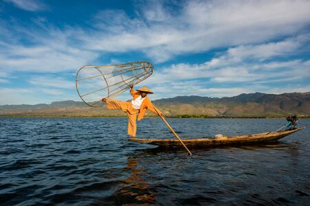 Nyaungshwe Township, Myanmar (Burma). January 11, 2019: Intha fisherman one leg stand pose with conical net , Inle Lake in the Nyaungshwe Townshipのeditorial素材