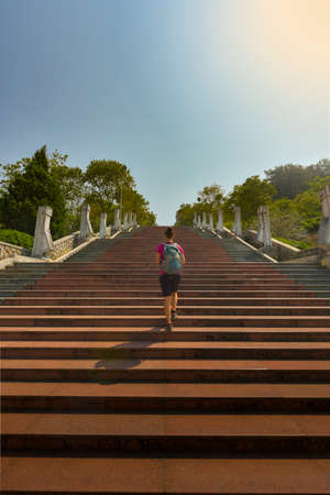 Tourist walks up the stairs to D1 Hill Dien Bien Phu Victory Monumentの写真素材