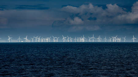 Windmill farm on the sea from the distanceの写真素材