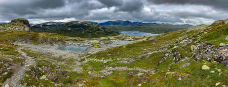 Panoramic view of StÃ¥vatn lake and Sveigen Haukeli, Trollnup peaks from the summit of Kista, Norwayの写真素材