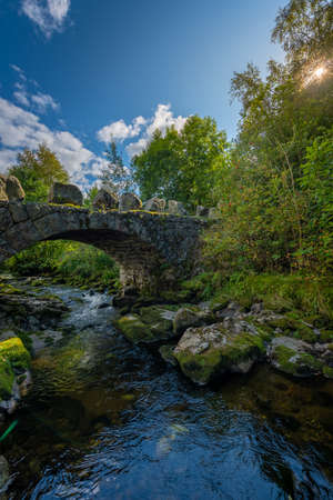 Arched stone bridge over Hauskeana, Hjelmeland, Norway.の写真素材