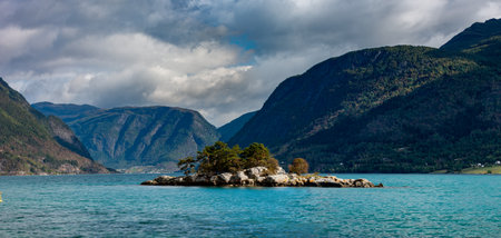 The view from KÃ¥ret Beach in Norway towards Lustrafjorden and small island in the middleの写真素材