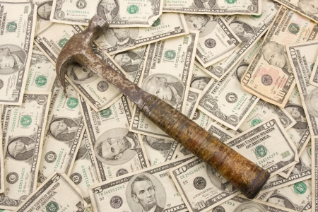 Hammer on background of money.の写真素材