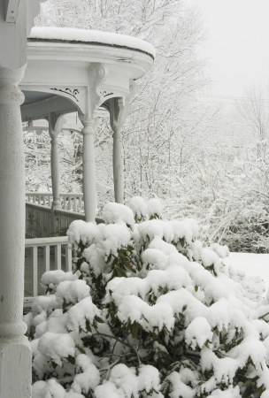 Snow covered Victorian porch in snowstrom の写真素材
