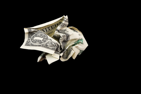 Crumpled one dollar bill on black Bakground の写真素材