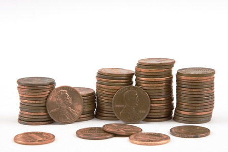 Stacks of pennies on white background の写真素材