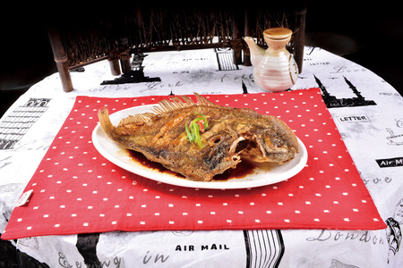 Fried fish with wooden decoration