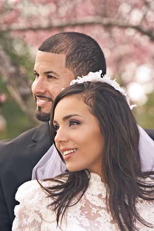 A Hispanic bridal couple is all smiles after their weddingの写真素材