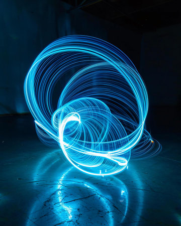 Abstract light painting in a dark room. Long exposure photograph with grain.の素材