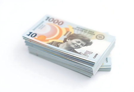 stack of money sitting on top of a white tableの素材