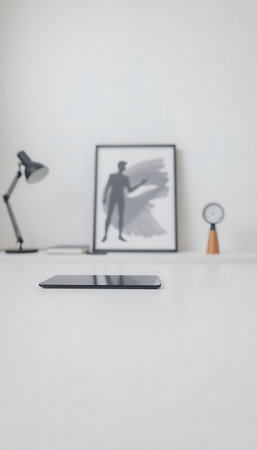 desk with a phone, lamp, and picture on itの素材