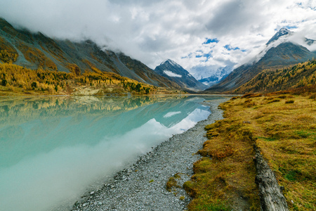 View from lake Akkem on mountain Belukha near board between Russia and Kazakhstan during golden autumnの写真素材