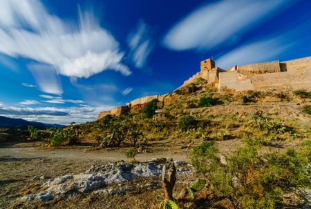 View on the castle Sagunto during sunny day and cloudy sunsetの写真素材
