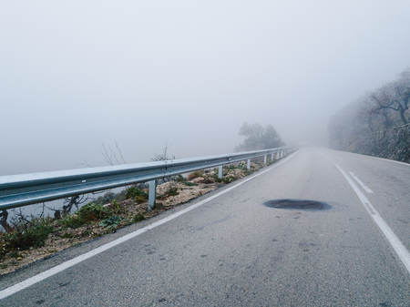 Mystical views of the road in dense fog in the mountains of the Iberian Peninsulaの写真素材