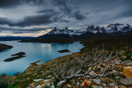 A view of the mountains and the lake during a sunset in the Torres del Paine National Park. Autumn in Patagonia, the Chilean sideの写真素材