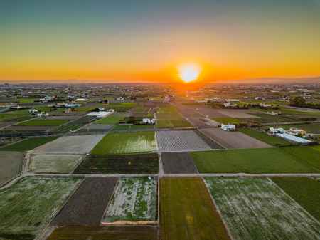 View from the air to the agrarian fields during a bright sunset near the bays of Port Saplaya. Valenciaの写真素材