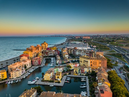 View from the air to the entrance to Port Saplaya Bay and agrarian fields around during a bright sunset. Valenciaの写真素材