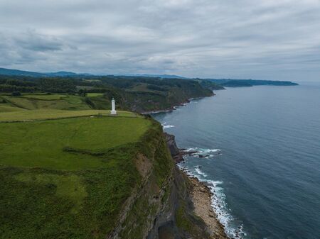Aerial view of the lighthouse and Cape Lastres. Bay of Biscay in northern Spain in summer.の写真素材