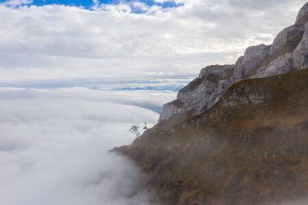 Aerial view of Mount Pilatus during sunrise and fog. Autumn Switzerland