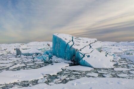 Aerial view of the J kuls rl n glacial lagoon and floating icebergs. The beginning of spring in...