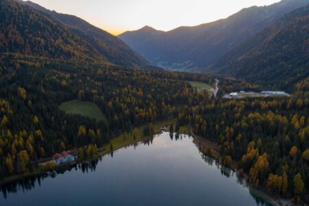 Aerial view of Lake Lago di Anterselva and autumn forest during sunset. Italian Alpsの写真素材