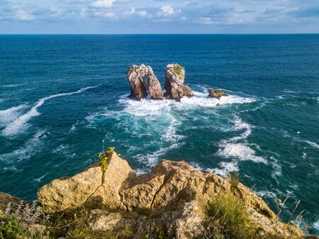 Aerial view of reefs and cliffs during sunset at Arnia Beach. Northern Spain in summerの写真素材