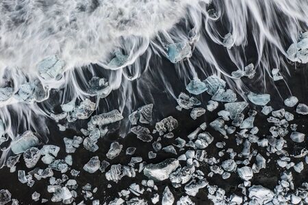 Aerial view of ice floes and icebergs on Diamond beach during sunset. The beginning of spring in Icelandの写真素材