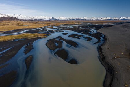 Aerial view of patterns of Icelandic rivers flowing into the ocean. Iceland in early springの写真素材