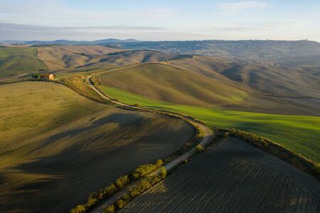 Aerial view of the fields, wineries near San Quirico dOrcia. Tuscany autumn sunriseの写真素材