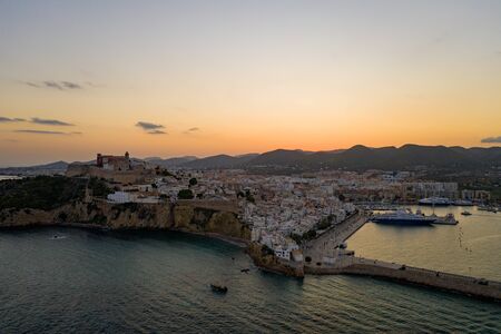 Aerial view of the old city on the island of Ibiza during sunset.