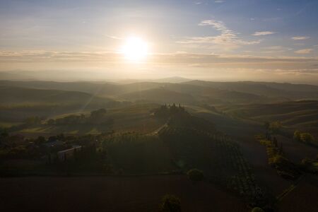 Aerial view of the fields, wineries near San Quirico dOrcia. Tuscany autumn sunrise