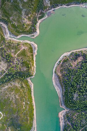 Aerial view of the valley, olive fields and Embalse de Forata reservoir during sunset. Summer in Spain.の写真素材
