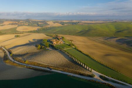 Tuscany, Siena, October 19, 2019. Aerial view of the fields, wineries near San Quirico dOrcia. Tuscany autumn sunriseのeditorial素材