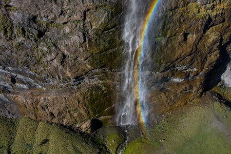 Aerial view of a waterfall and rainbow in the village of Lauterbrunnen. Switzerland in the fallの写真素材