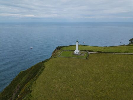 Aerial view of the lighthouse and Cape Lastres. Bay of Biscay in northern Spain in summerの写真素材