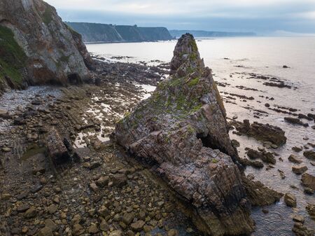 Aerial view of the coastline and cliffs during sunset on the beach of Quintana and Estaca. Northern...