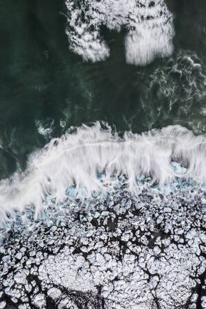Aerial view of ice floes and icebergs on Diamond beach during sunset. The beginning of spring in Iceland.の写真素材