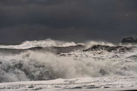 Stormy waves at black volcanic beach near famous Reynisfjara rocks at south coast of Icelandの写真素材