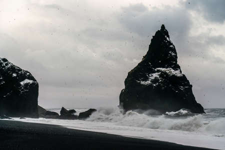 Basalt rock formations Troll toes on black beach. at storm Reynisdrangar, Vik, Icelandの写真素材