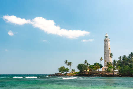 Beautiful beach and White lighthouse Dondra in Sri Lanka.の写真素材