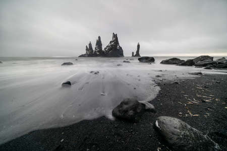 Basalt rock formations Troll toes on black beach. at storm Reynisdrangar, Vik, Icelandの写真素材