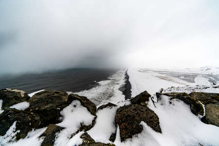 View of Kirkjufjara black sand beach from Dyrholaey promontory. Vik i Myrdal village, South Icelandの写真素材