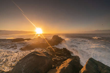 View from cape Dyrholaey on Reynisfjara Beach and Reynisdrangar basalt sea stacks, Iceland. Stormy sunriseの写真素材